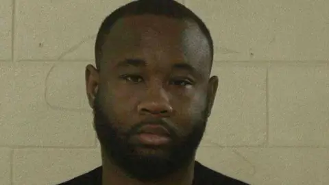 Liberty County Sheriff's Office/ CBS The suspect seen in a mugshot
