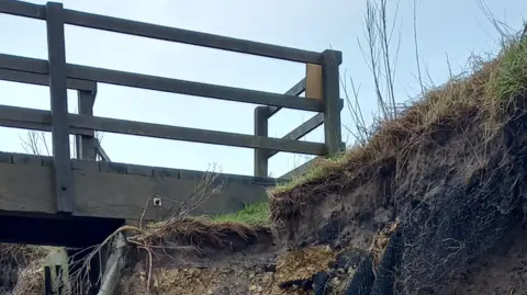 Northumberland County Council  The top of some steps showing badly eroded cliff