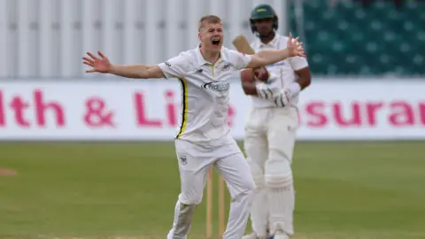Luke Charlesworth celebrates after taking a wicket for Gloucestershire